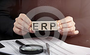 ERP Enterprise Resource Planning on wooden block.Leadership Strategy Management Finance Business Concept