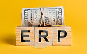 ERP with money on a yellow background. The concept of business, finance, credit, income, savings, investments, exchange, tax