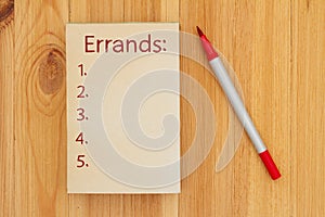 Errands list on retro old paper notepad with marker photo