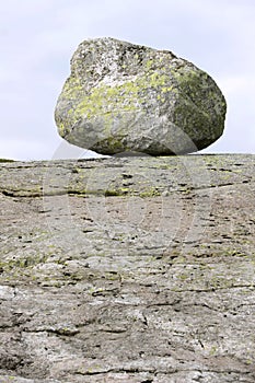 Erratic stone on the granite rock.