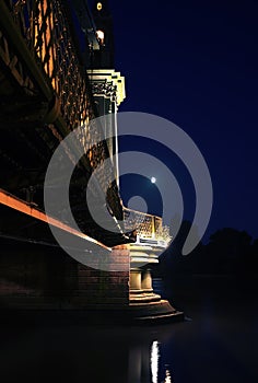 Errie bridge shot at night with cresent moon in sky