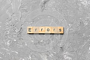 Errors word written on wood block. Errors text on cement table for your desing, concept