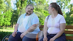 Erudite obese man telling interesting stories to pretty girl, self-confidence