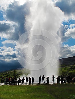 Erupting geyser and tourists, Iceland