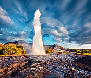 Erupting of the Great Geysir lies in Haukadalur valley on the slopes of Laugarfjall hill.