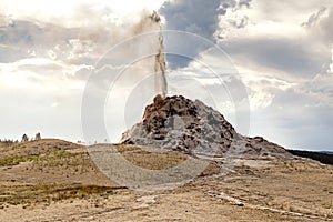 Erupting White dome geyser in Yellowstone National Park, Wyoming, USA