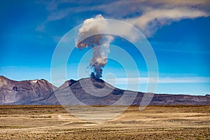 The eruption of the active volcano Sabancaya on 09/20/2022 with an ash plume in the blue sky near the town of Chivay in the Colca