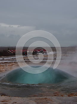 The eruption of the Strokkur geyser in the southwestern part of Iceland in a geothermal area near the river Hvitau