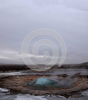 The eruption of the Strokkur geyser in the southwestern part of Iceland in a geothermal area near the river Hvitau