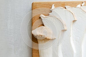 Eryngii mushroom on a wooden cutting board. The process of cooking Gochujang King Oyster Mushrooms. photo