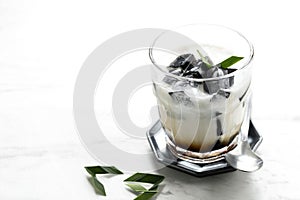 Es Cincau Hitam or Black Grass Jelly Cincau Hitam, Indonesian Dessert Made from Cincau Leaf with Coconut Milk and Palm Sugar.