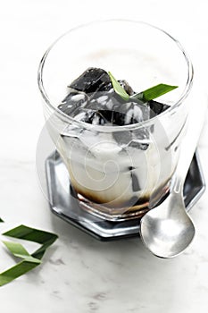 Es Cincau Hitam or Black Grass Jelly Cincau Hitam, Indonesian Dessert Made from Cincau Leaf with Coconut Milk and Palm Sugar.