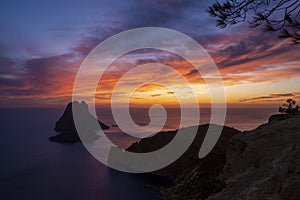 Es Vedra islet and the cape of Jueu at sunset