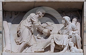 Esau selling his birthright to Jacob, marble relief on the facade of the Milan Cathedral photo