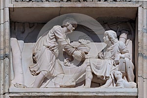 Esau selling his birthright to Jacob, marble relief on the facade of the Milan Cathedral photo