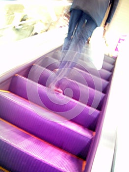 Escalator and blurry man in movement