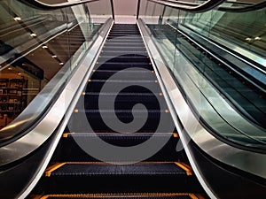 Escalator in an empty shopping mall