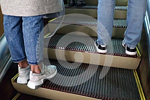 On the escalator feet of two people.