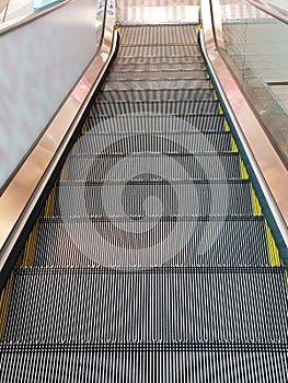 escalator go down in building. electric steel stairs up and down floor