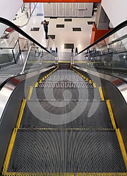 Escalator inside a modern building. Moving staircase without people.