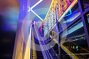 Escalator with LED light beside in technology abstract neon colorful light theme