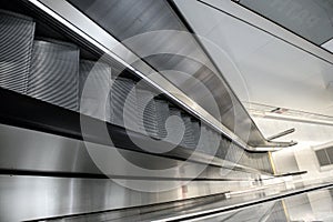 escalator in a modern building with white marble walls