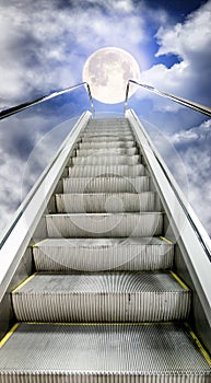 The escalator is moving up to the starry sky with a moon