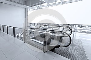 Escalator in the room with glass