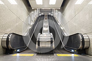 Escalator up and down in a building.