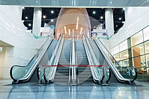 Escalator up and down in a building.