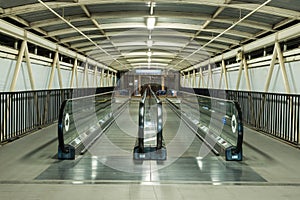 Escalator up and down in a building.