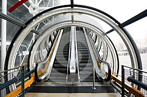 Escalator up and down with tunnel in modern building