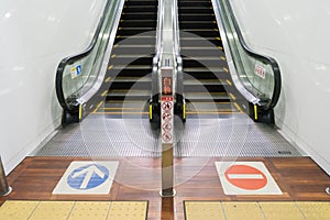 An escalator upstair way and downstair way