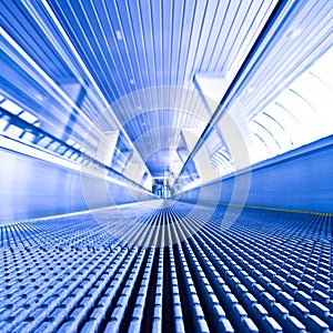 Escalator view in blue corridor