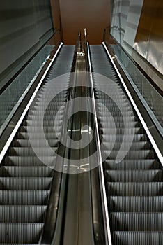 Escalators in an empty shopping mall in Singapore with motion blur effect