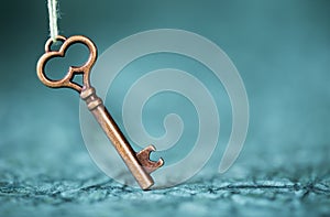 Escape room concept. Vintage key on blue background with copy space photo