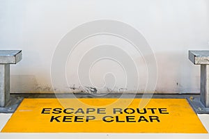 Escape route, keep clear sign blocked by concrete wall with copy space, clipping path for travel image adaptation