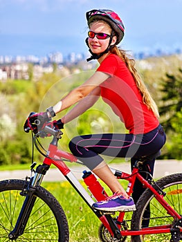 Escape urban . Bicycle girl wearing helmet rest from city urbanization.