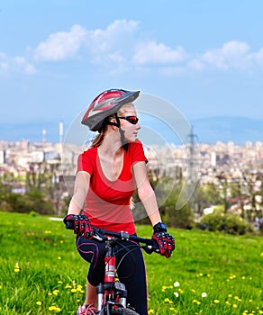 Escape urban . Bicycle girl wearing helmet rest from city urbanization.