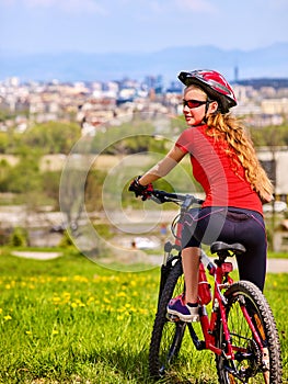 Escape urban . Bicycle girl wearing helmet rest from city urbanization. photo