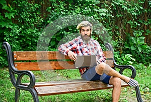 Escaped of office. successful entrepreneur. mature man sitting on park bench with laptop and checking email. Freelancer