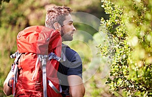 Escaping into nature. a young man enjoying a hike through the mountains.