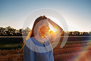 Escapism, getting away from it all, mental health, Stress resilience. Alone Young woman in linen dress walking on mowed