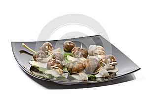 Escargots in a black plate