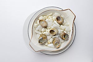 Escargots de Bourgogne. Fried snails with garlic butter, gourmet dish, in traditional ceramic plate