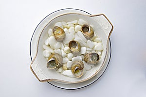 Escargots de Bourgogne. Fried snails with garlic butter, gourmet dish, in traditional ceramic plate