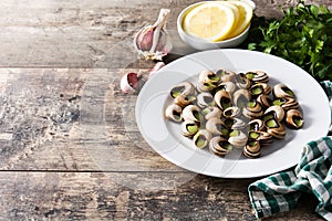 Escargots de Bourgogne on wooden table