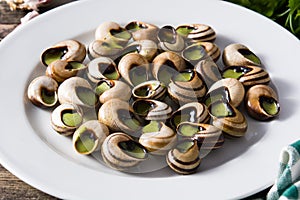 Escargots de Bourgogne on wooden table