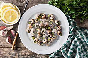 Escargots de Bourgogne on wooden table