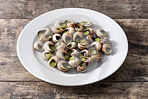 Escargots de Bourgogne on wooden table